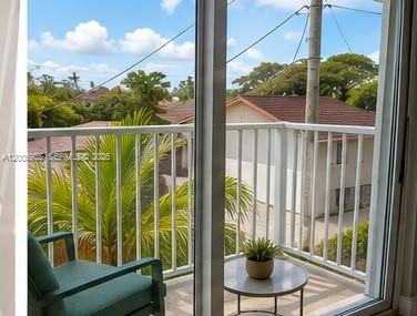 948 Southwest 3rd Street, Unit 205 Miami, FL 33130 - Photo 9 of 11 a view of a balcony with floor to ceiling window and wooden fence