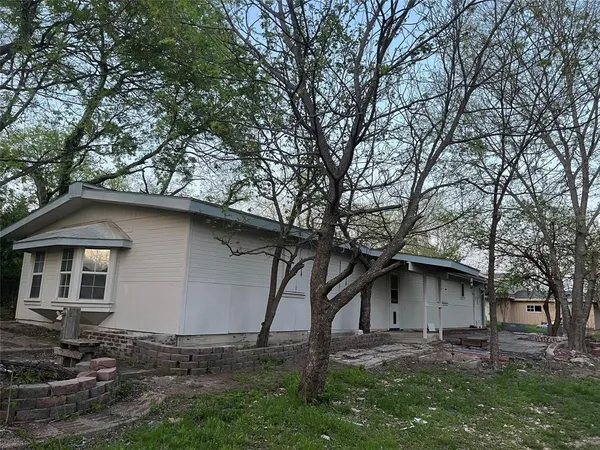 a house with trees in the background