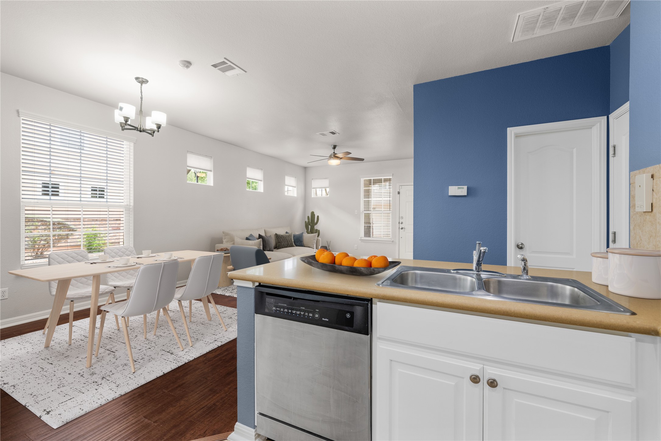 11000 Anderson Mill Road, Unit 45 Austin, TX 78750 - Photo 3 of 32 a kitchen with a table chairs and white cabinets