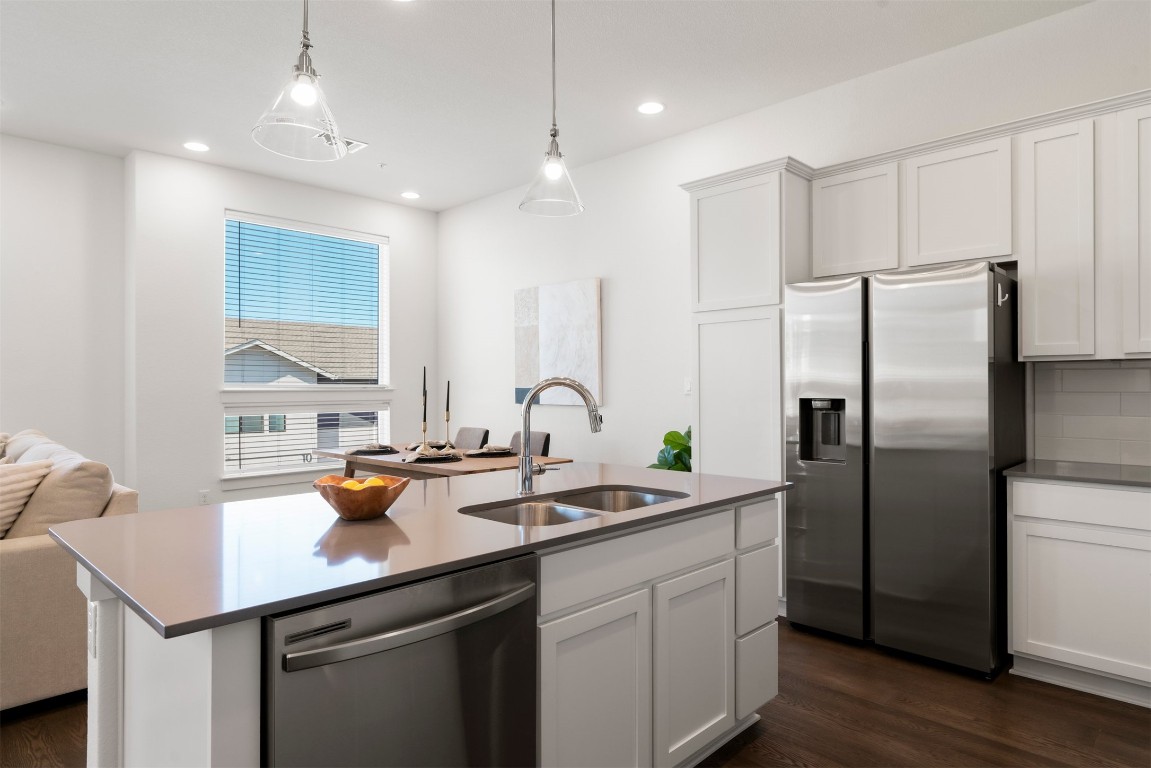 2050 Lohmans Spur Road, Unit 2203 Lakeway, TX 78734 - Photo 21 of 34 Open to the living room and dining area, the kitchen stays connected to the rest of the home