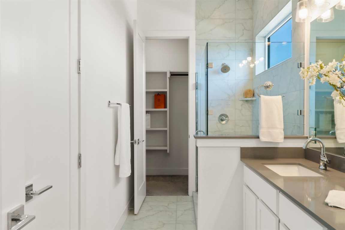 2050 Lohmans Spur Road, Unit 2203 Lakeway, TX 78734 - Photo 25 of 34 A step-in shower creates a spa-like experience without feeling overdone, balancing style with everyday ease