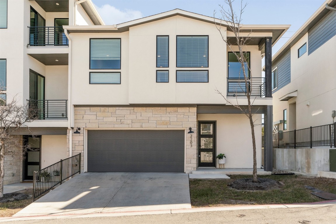 2050 Lohmans Spur Road, Unit 2203 Lakeway, TX 78734 - Photo 33 of 34 The attached two-car garage provides generous space for parking plus extra room for bikes, gear, and seasonal storage