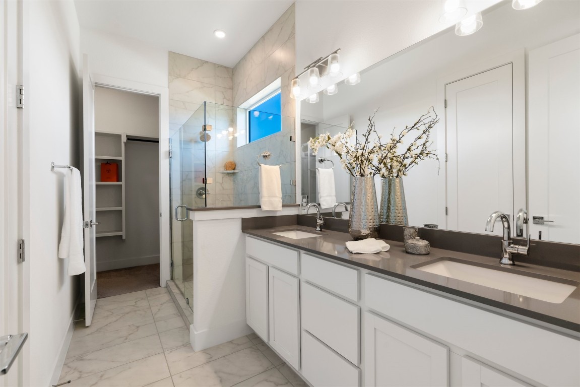 2050 Lohmans Spur Road, Unit 2203 Lakeway, TX 78734 - Photo 7 of 34 The primary bathroom is designed with comfort in mind, featuring a wide dual-sink vanity that keeps mornings and evenings running smoothly