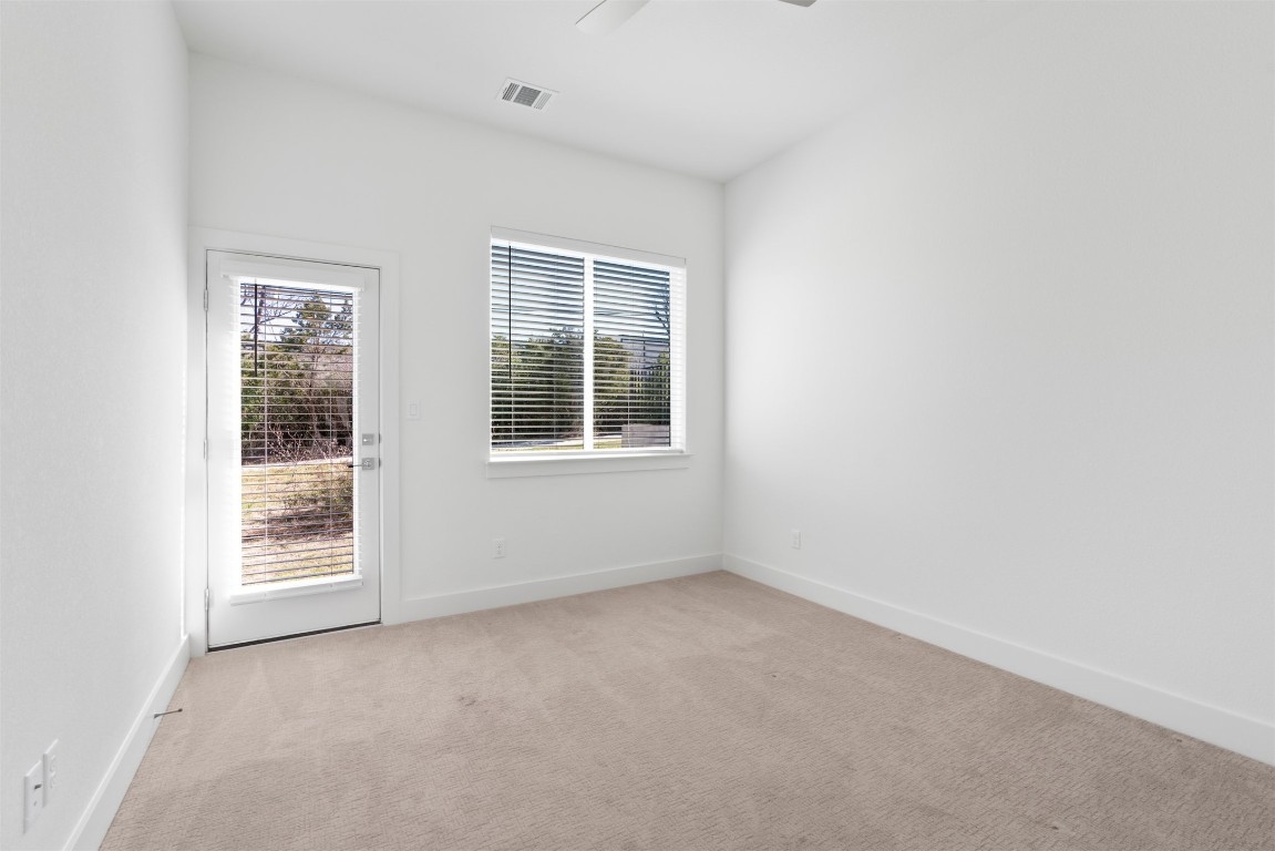 2050 Lohmans Spur Road, Unit 2203 Lakeway, TX 78734 - Photo 10 of 34 The main floor guest bedrooms are well sized and quietly tucked away, offering comfortable, private spaces that work just as easily for overnight guests as they do for a home office or flex room