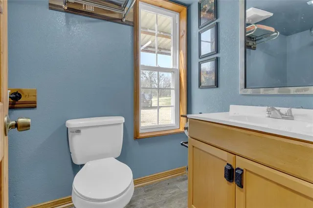 a white toilet sitting next to a bathroom sink