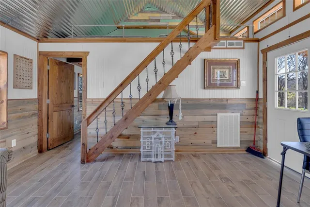 a view of entryway and hall with wooden floor