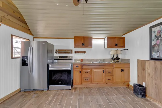 a kitchen with stainless steel appliances granite countertop a refrigerator and a stove top oven