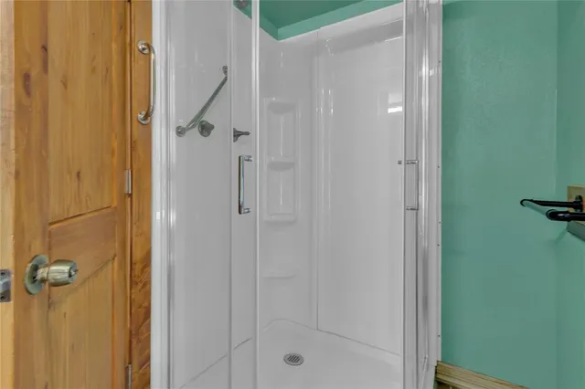 a bathroom with a glass shower door
