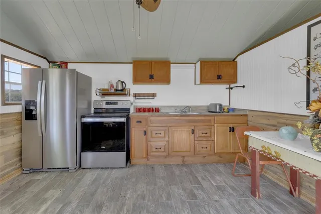 a kitchen with sink cabinets and stainless steel appliances