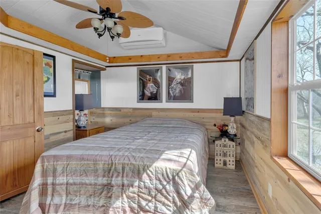 a bedroom with a large bed and a chandelier