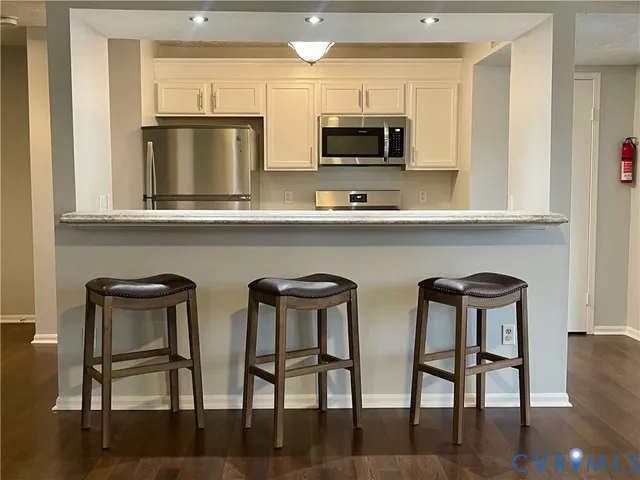 a view of kitchen with chairs and microwave