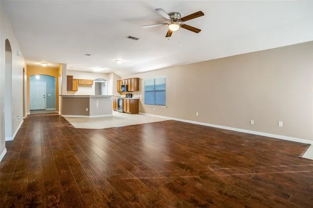 a view of a kitchen with a sink and dishwasher with wooden floor