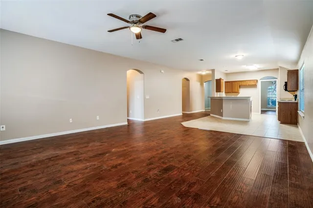 a view of a kitchen with furniture and a ceiling fan