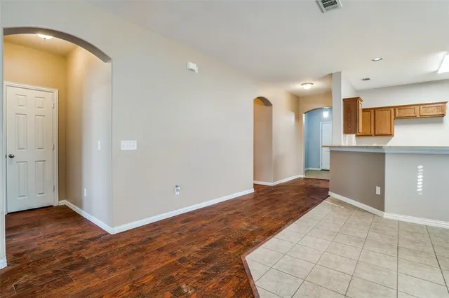 a view of a kitchen with wooden floor and a sink