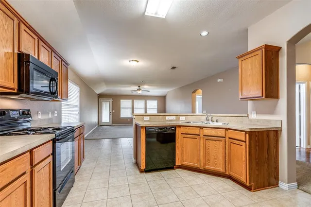 a kitchen with a sink stove and cabinets