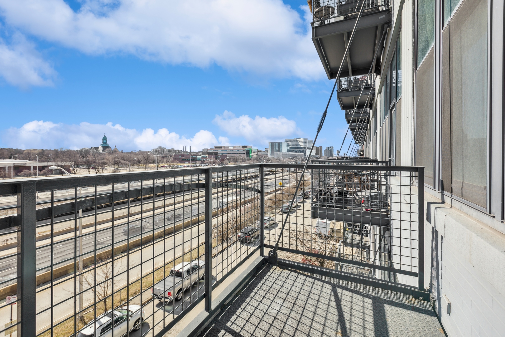 1224 West Van Buren Street, Unit 301 Chicago, IL 60607 - Photo 13 of 14 a view of balcony with wooden floor and city view