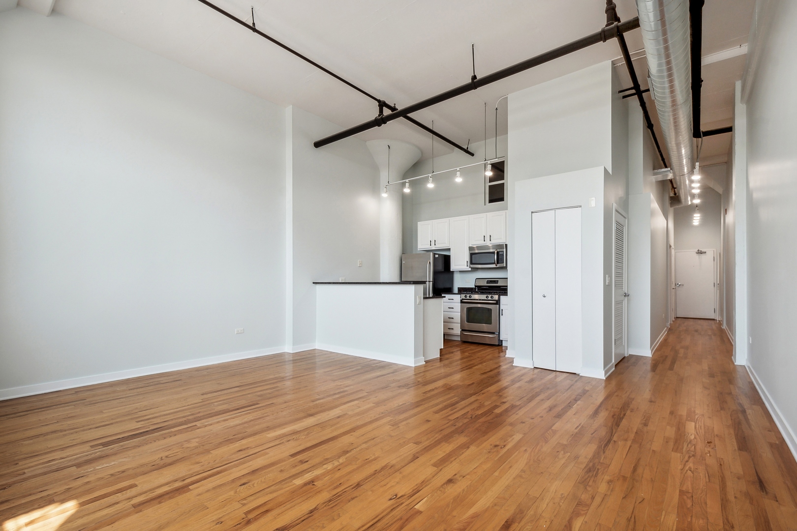 1224 West Van Buren Street, Unit 301 Chicago, IL 60607 - Photo 5 of 14 a view of a kitchen with wooden floor