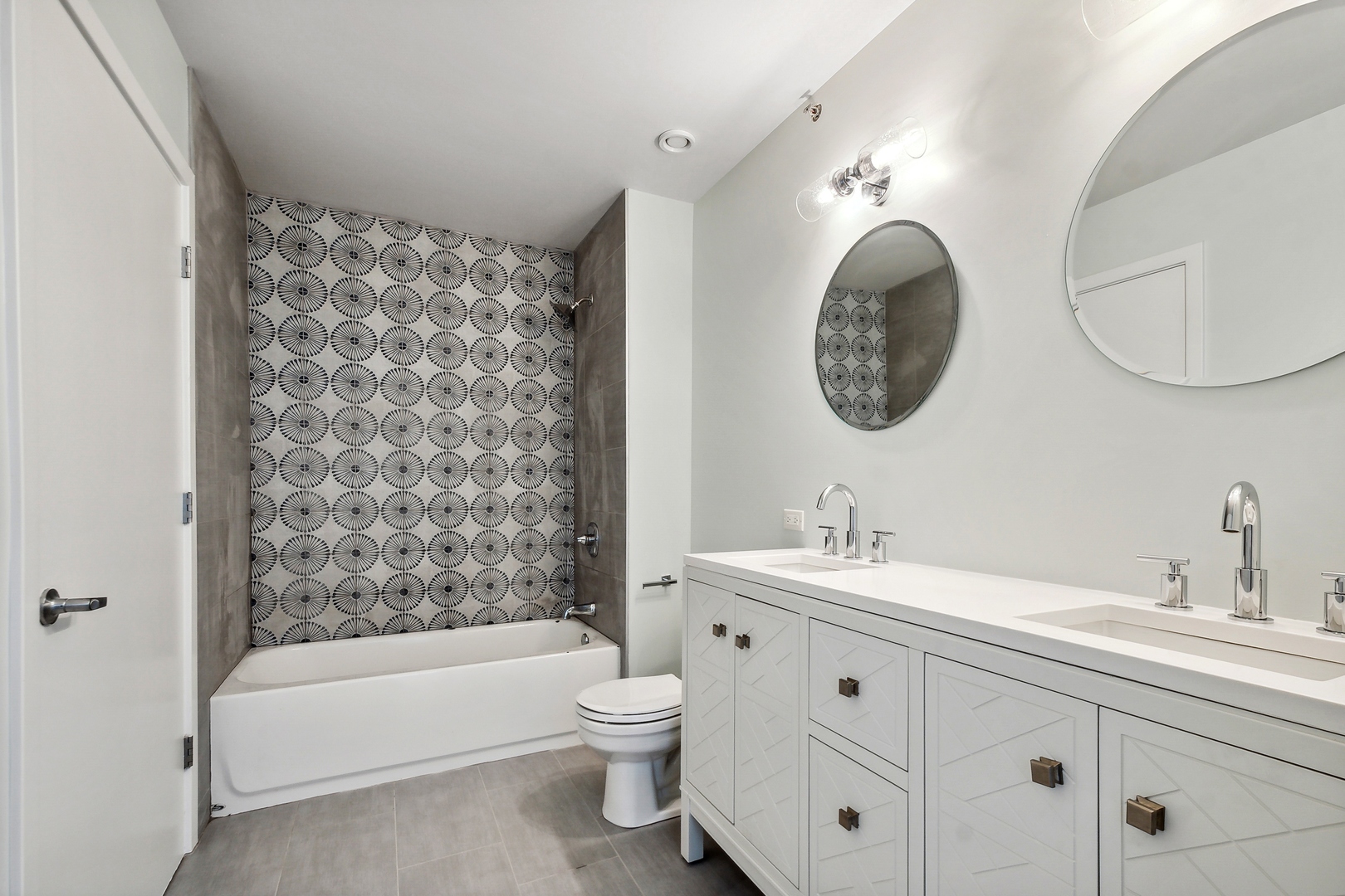 1224 West Van Buren Street, Unit 301 Chicago, IL 60607 - Photo 7 of 14 a bathroom with a double vanity sink mirror and bathtub
