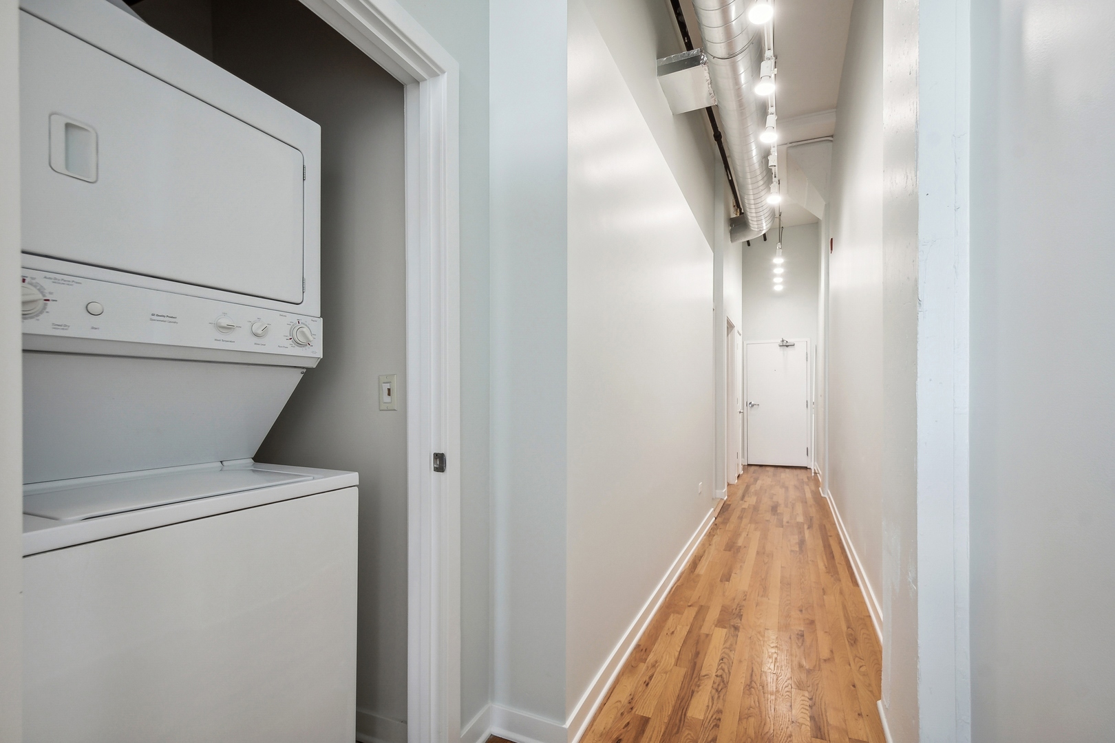 1224 West Van Buren Street, Unit 301 Chicago, IL 60607 - Photo 10 of 14 a view of a hallway with washer and dryer