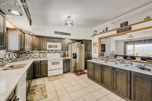 a kitchen with stainless steel appliances kitchen island granite countertop a sink and cabinets