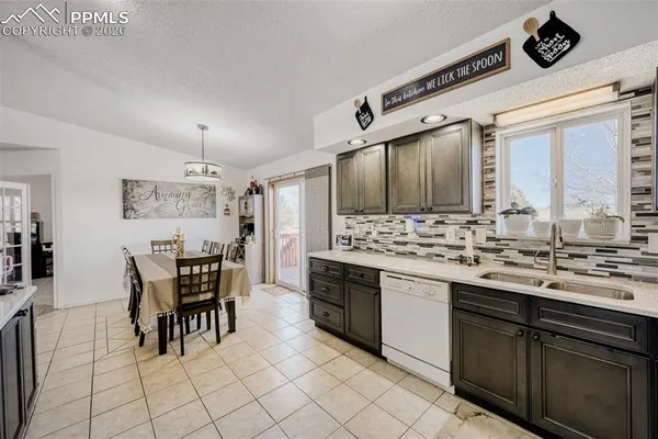 a living room with furniture and a view of kitchen