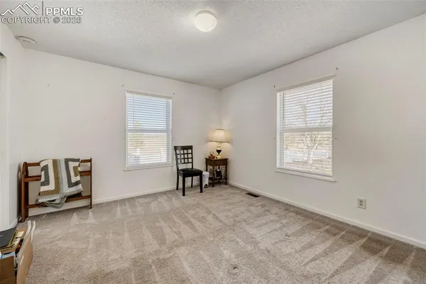 a bathroom with a granite countertop sink a toilet a mirror and shower