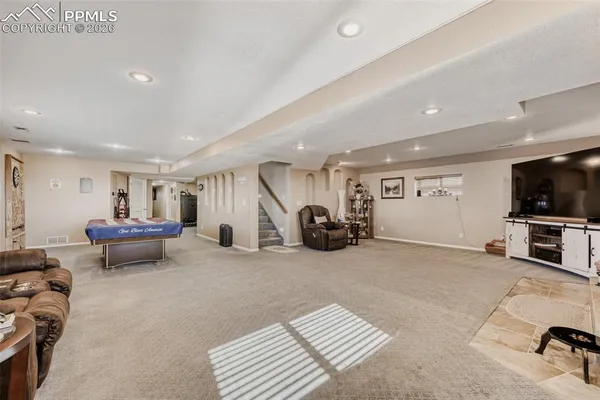 a spacious bedroom with a bed and cabinet