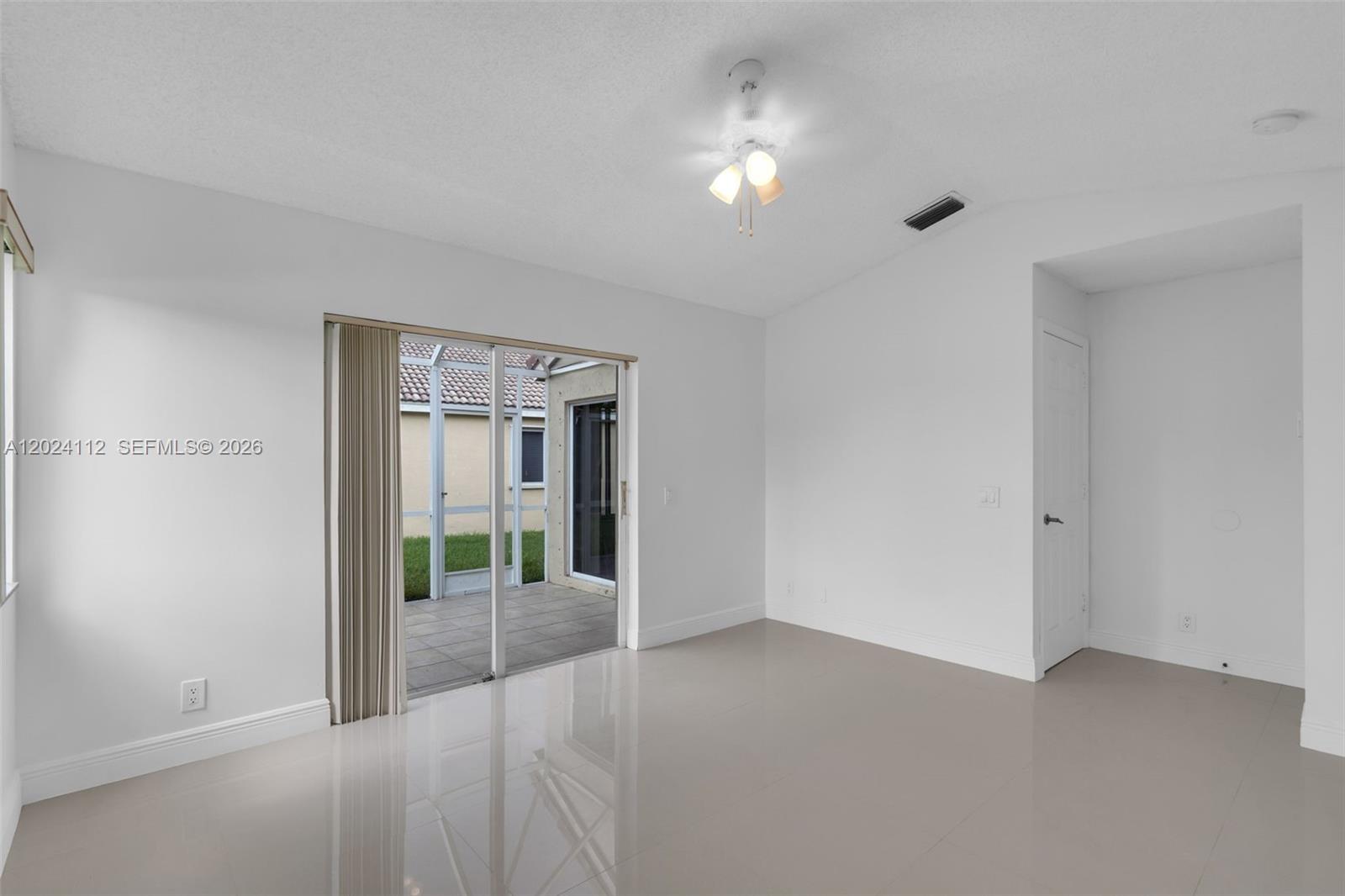 4366 Mahogany Ridge Drive Weston, FL 33331 - Photo 14 of 41 an empty room with floor to ceiling window and an empty room