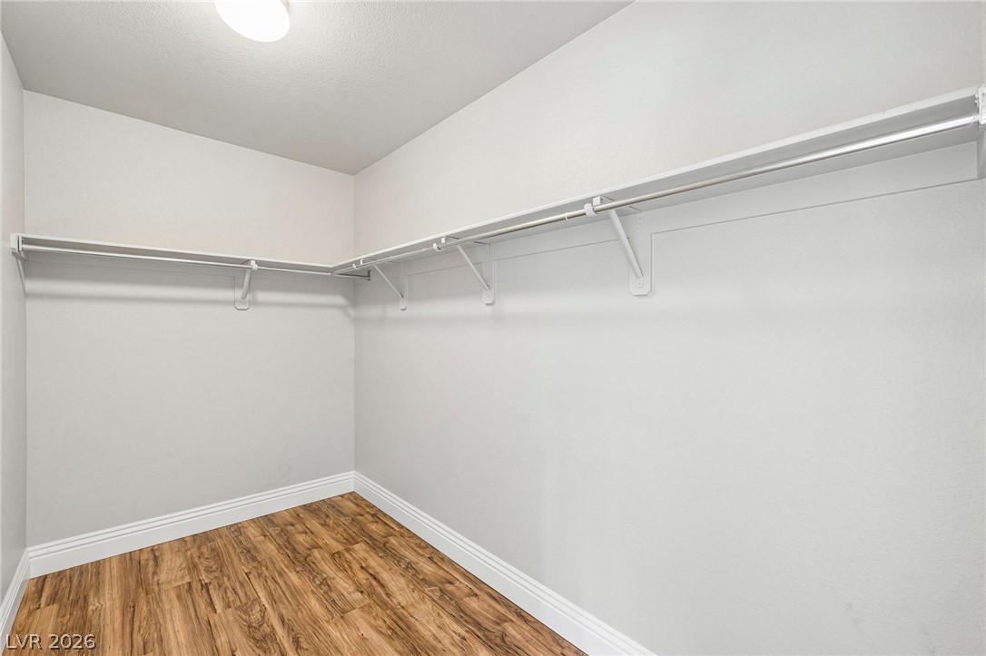 1176 Butternut Ranch Court Henderson, NV 89052 - Photo 34 of 60 Ample hanging space and durable flooring define this well-appointed walk-in closet.