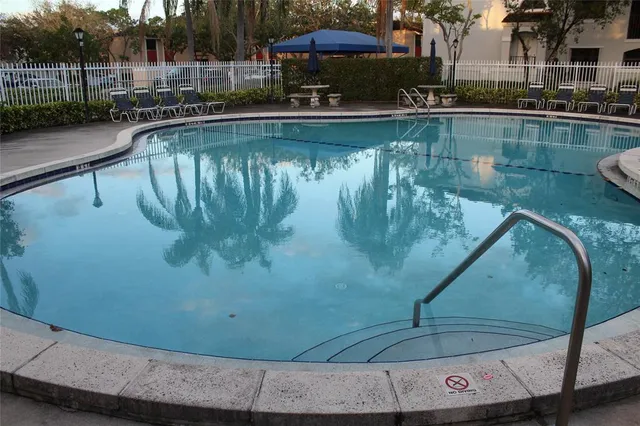 a view of a swimming pool with a yard