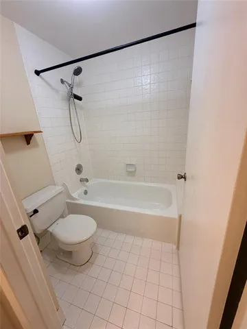a bathroom with a granite countertop sink a toilet and a bathtub