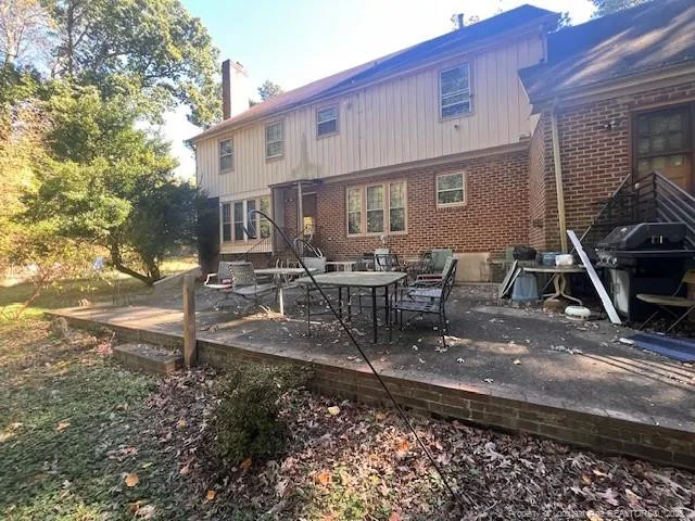 a view of a house with backyard porch and sitting area