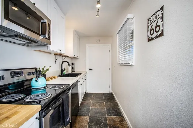 a kitchen with stainless steel appliances granite countertop a stove and a sink