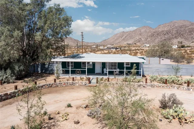 a view of a house with a yard covered in snow