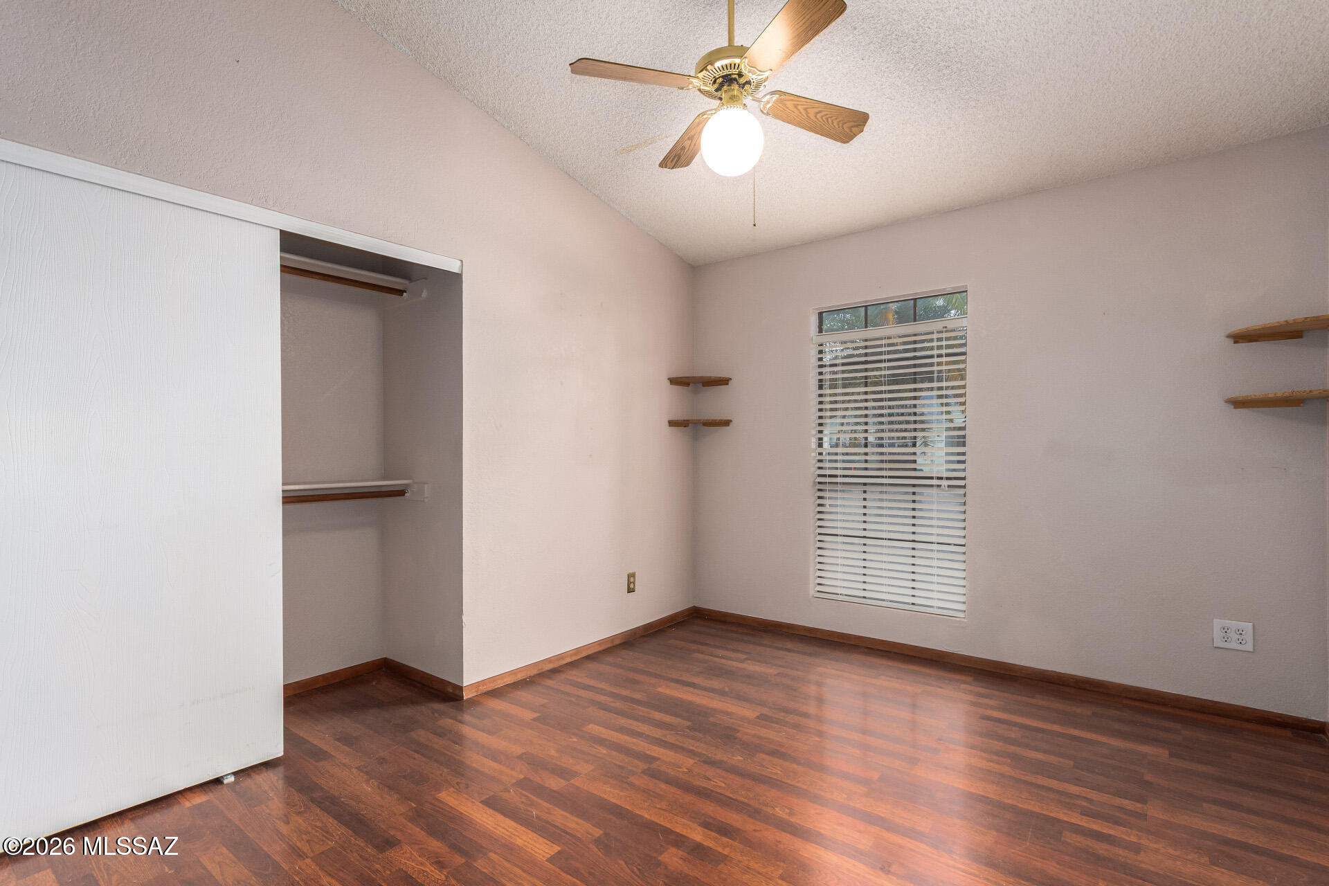 5331 West Eaglestone Loop Tucson, AZ 85742 - Photo 25 of 35 an empty room with wooden floor chandelier fan and windows