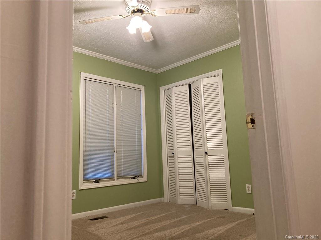 1851 Stoney Point Road Shelby, NC 28150 - Photo 18 of 26 an empty room with wooden floor fan and windows