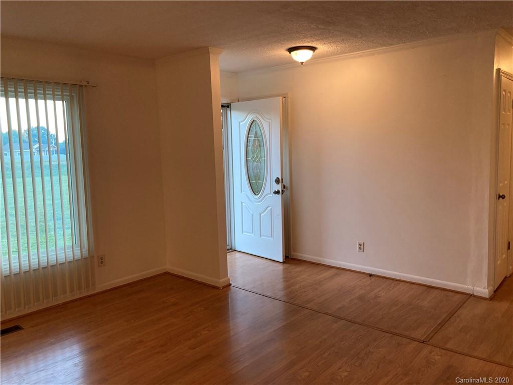 1851 Stoney Point Road Shelby, NC 28150 - Photo 10 of 26 an empty room with wooden floor and windows