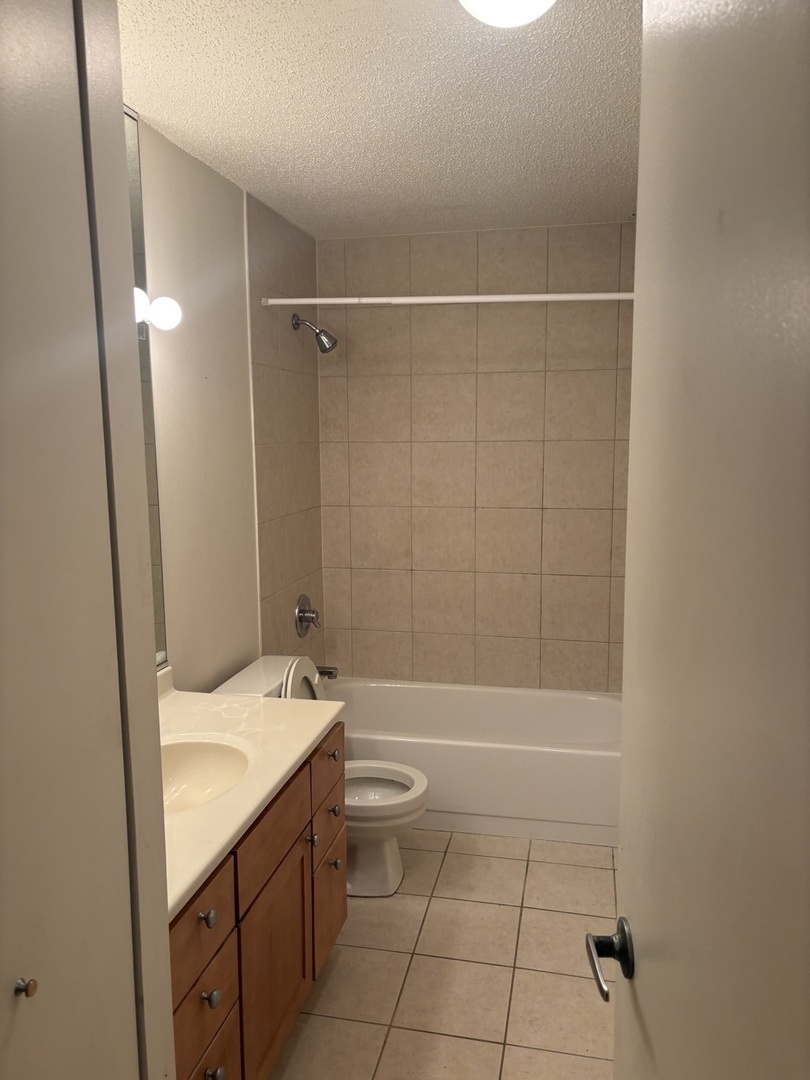 30 East Huron Street, Unit 3601 Chicago, IL 60611 - Photo 8 of 15 a bathroom with a granite countertop sink toilet and shower