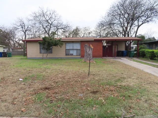a house that has a tree in front of it