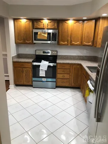 a kitchen with stainless steel appliances kitchen island granite countertop a sink and a stove