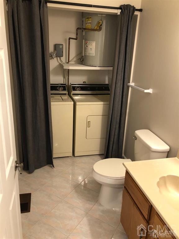 126 Concordia Circle, Unit G Monroe Township, NJ 08831 - Photo 11 of 14 a bathroom with a granite countertop toilet and a sink