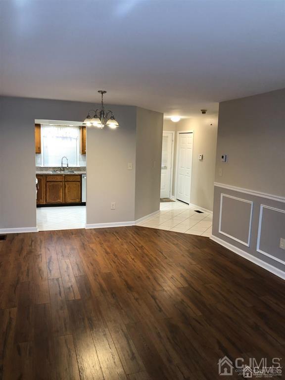 126 Concordia Circle, Unit G Monroe Township, NJ 08831 - Photo 6 of 14 a view of a room with wooden floor and kitchen space