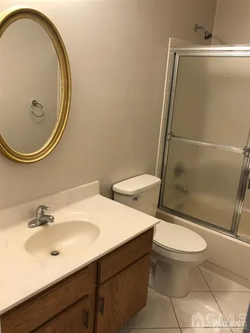 a bathroom with a sink mirror vanity and toilet