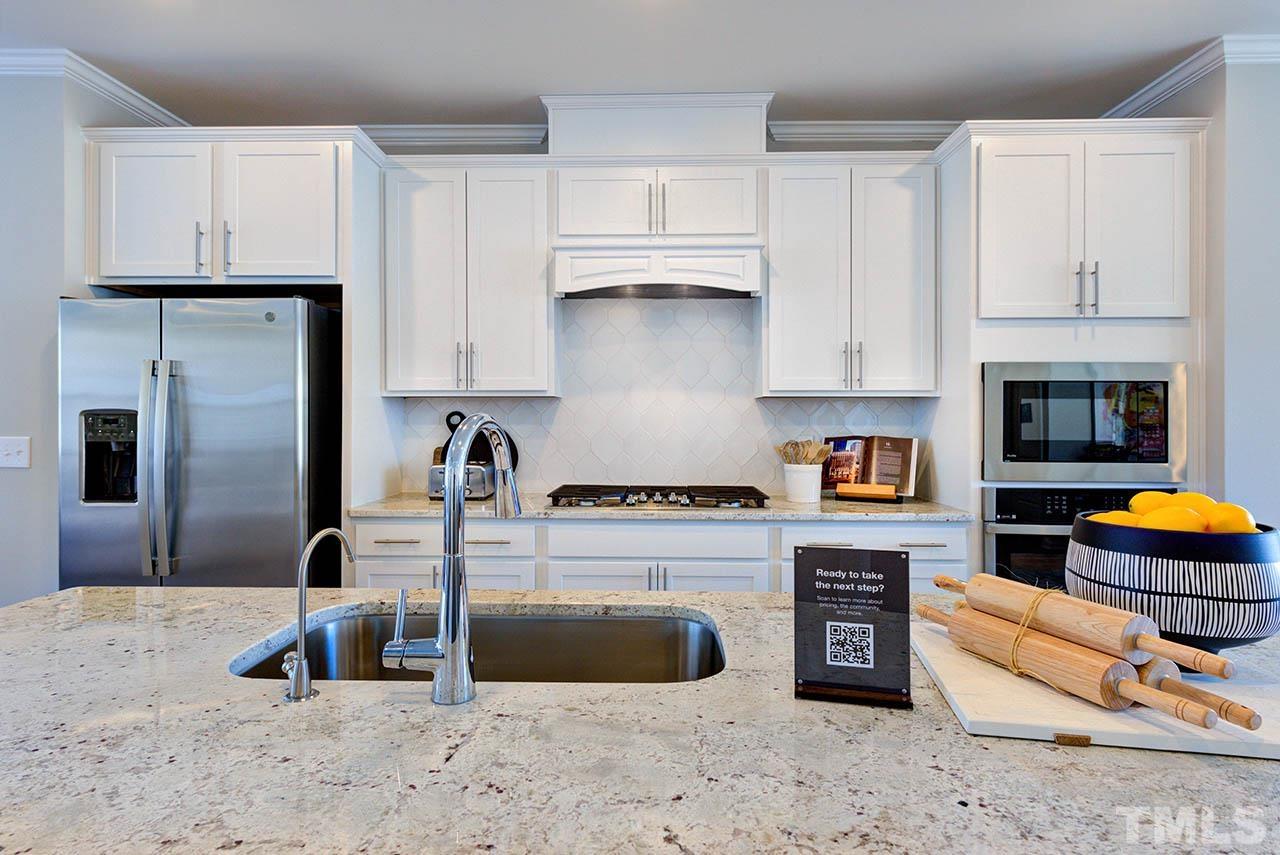 6932 Leesville Road, Unit 7 Raleigh, NC 27613 - Photo 16 of 44 a kitchen with stainless steel appliances granite countertop a refrigerator sink and stove