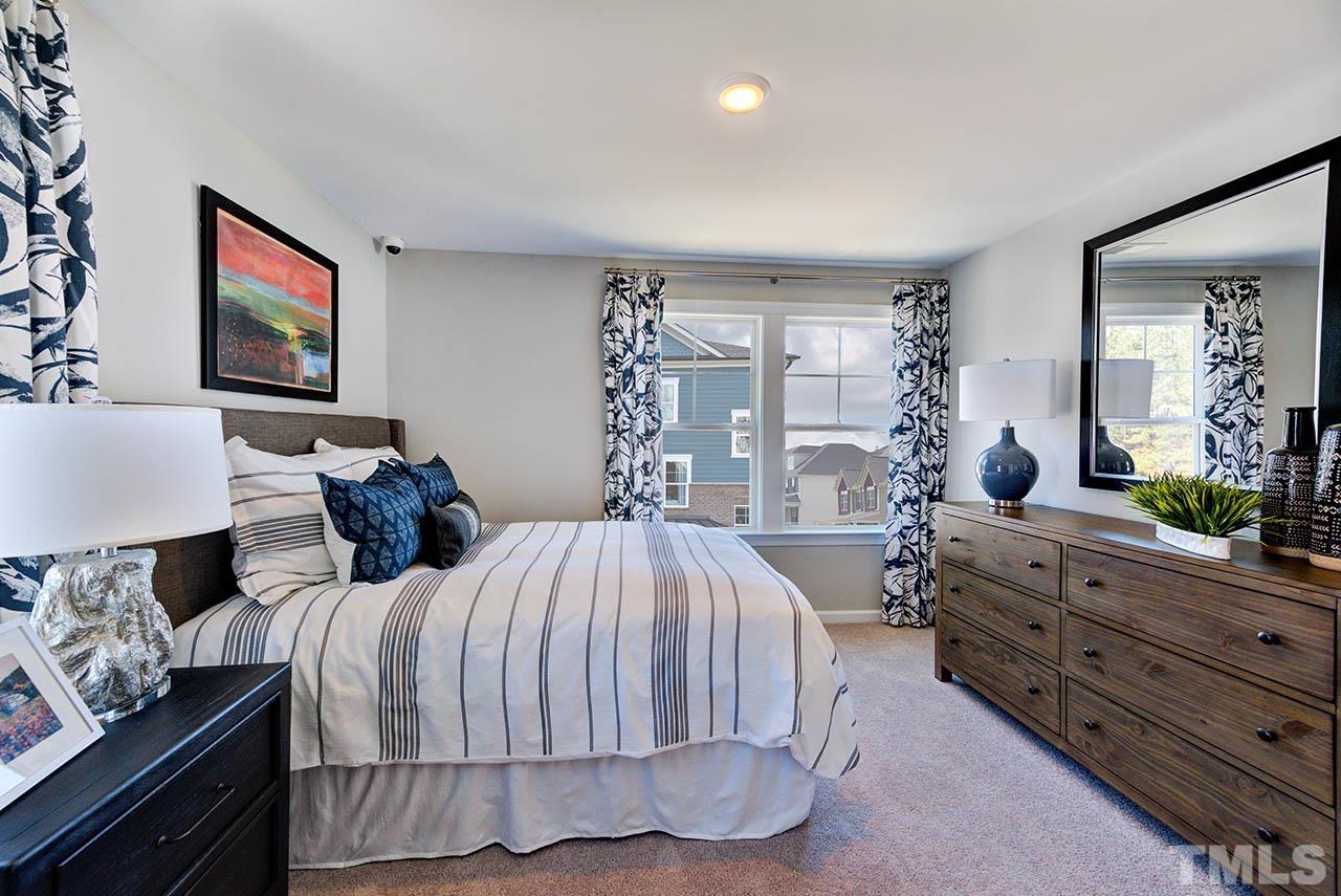 6932 Leesville Road, Unit 7 Raleigh, NC 27613 - Photo 27 of 44 a bedroom with a bed and a dresser