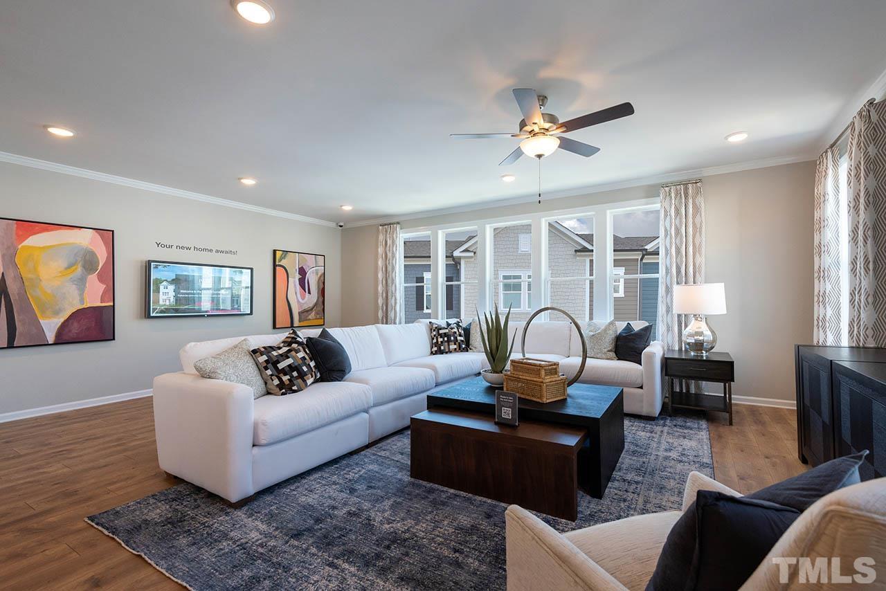 6932 Leesville Road, Unit 7 Raleigh, NC 27613 - Photo 30 of 44 a living room with furniture ceiling fan and a rug