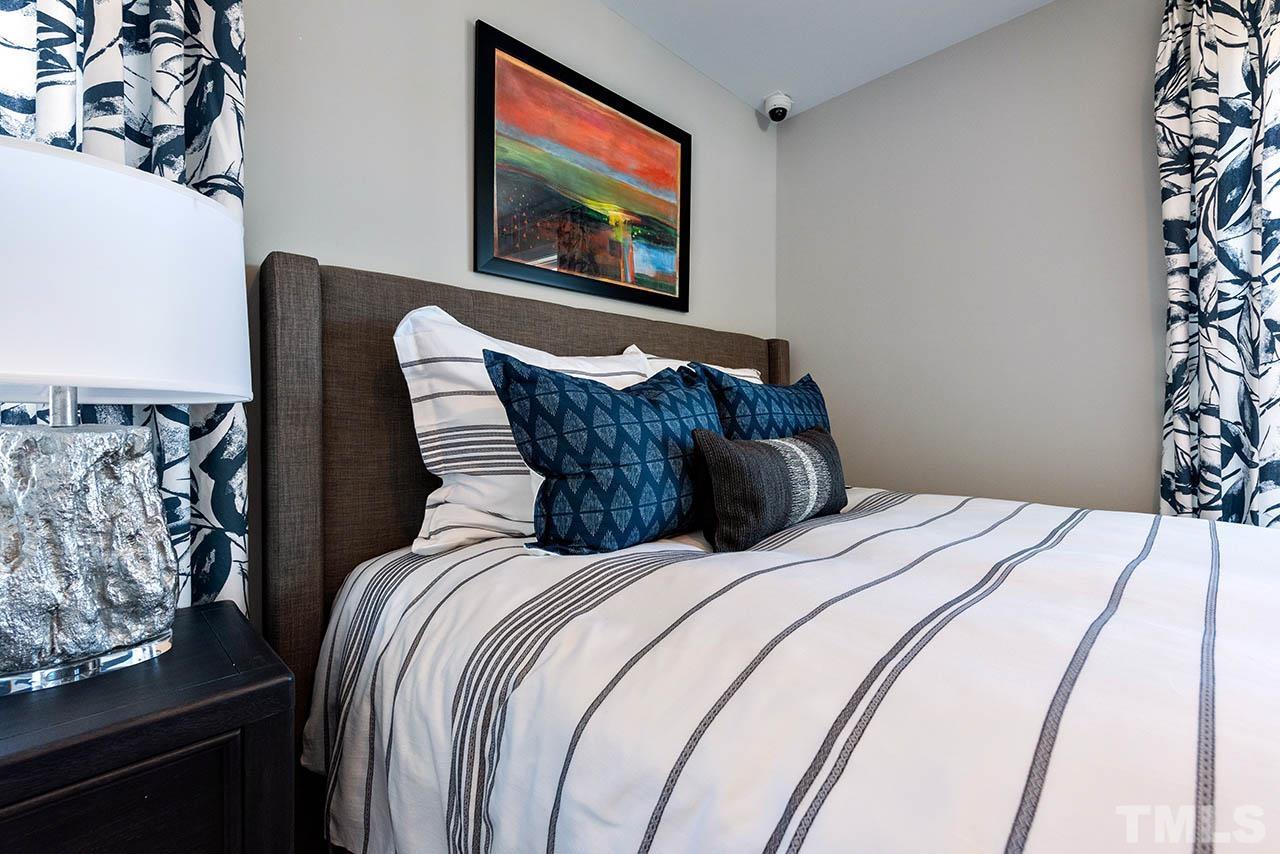 6932 Leesville Road, Unit 7 Raleigh, NC 27613 - Photo 39 of 44 a bedroom with bed and a painting on the wall