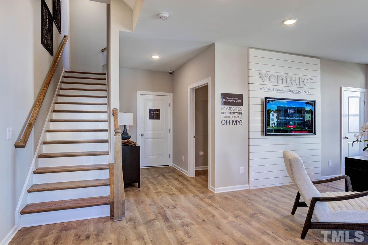 6932 Leesville Road, Unit 7 Raleigh, NC 27613 - Photo 6 of 44 a view of a hallway with wooden floor and windows