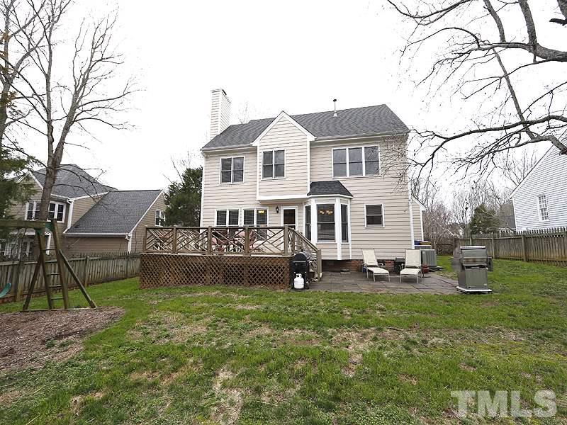 9112 Cub Trail Raleigh, NC 27615 - Photo 13 of 13 a front view of a house with a garden and trees