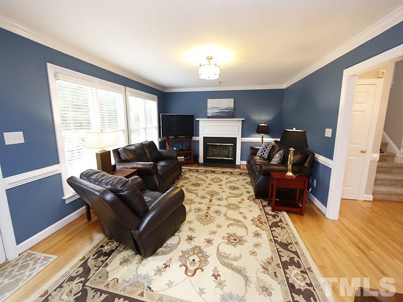9112 Cub Trail Raleigh, NC 27615 - Photo 3 of 13 a living room with furniture and a fireplace